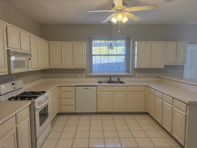 kitchen featuring sink, white appliances, light tile patterned floors, and ceiling fan