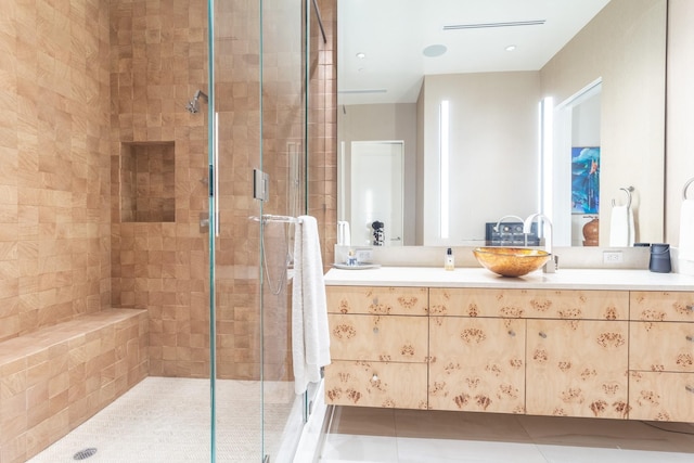 bathroom with vanity, an enclosed shower, and tile patterned floors