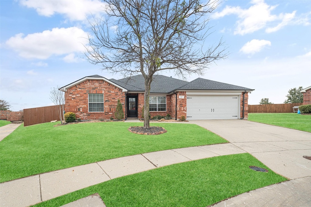 ranch-style home featuring a garage and a front yard