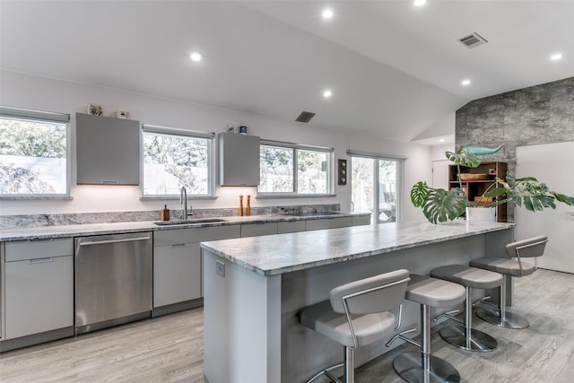 kitchen featuring a center island, sink, dishwasher, and gray cabinetry