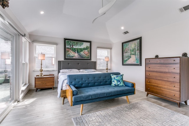 bedroom featuring lofted ceiling and light hardwood / wood-style flooring