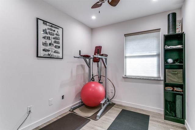 exercise room featuring ceiling fan and light wood-type flooring