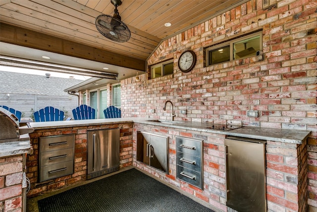 view of patio with area for grilling and sink