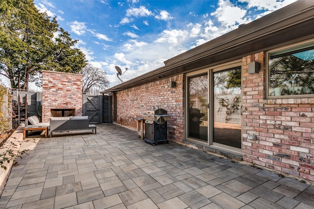 view of patio / terrace with area for grilling and a fireplace