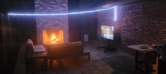 interior space with brick wall and a brick fireplace