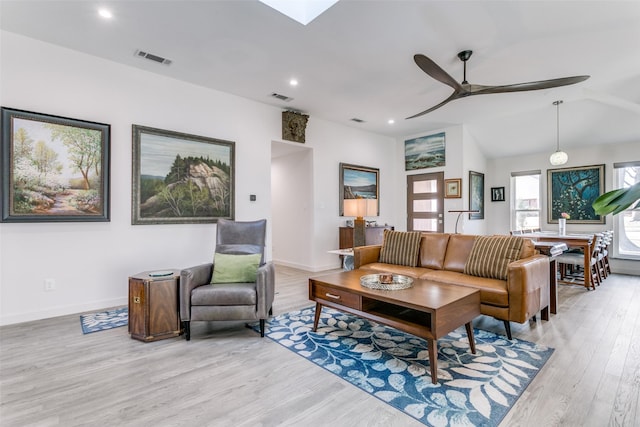 living room with vaulted ceiling, ceiling fan, and light hardwood / wood-style flooring