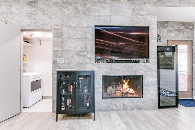 room details featuring hardwood / wood-style flooring, beverage cooler, and a tiled fireplace