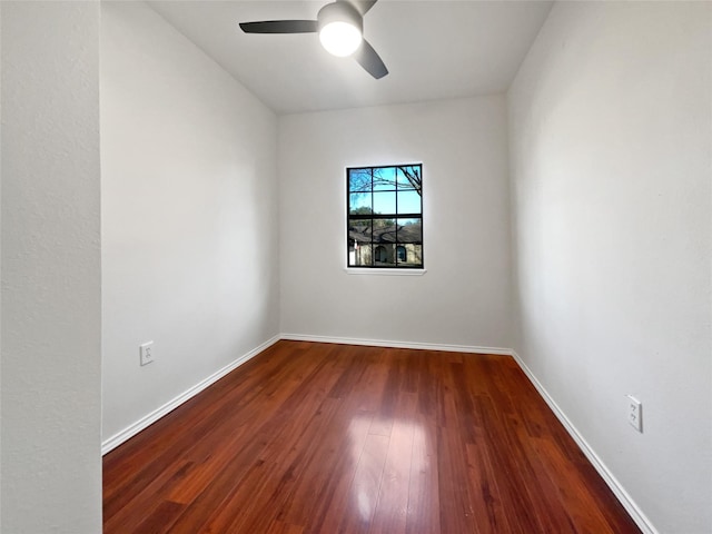 empty room featuring ceiling fan and dark hardwood / wood-style flooring