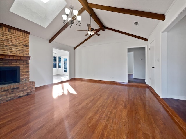 unfurnished living room with dark hardwood / wood-style flooring, a brick fireplace, ceiling fan with notable chandelier, and lofted ceiling with beams