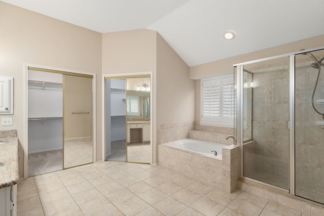 bathroom with lofted ceiling, vanity, independent shower and bath, and tile patterned flooring