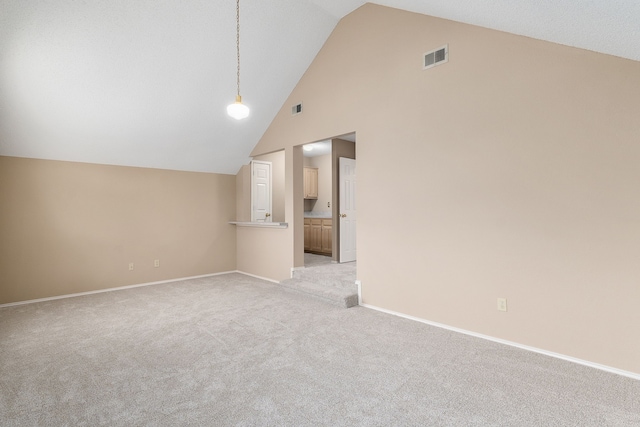 interior space featuring high vaulted ceiling and light carpet