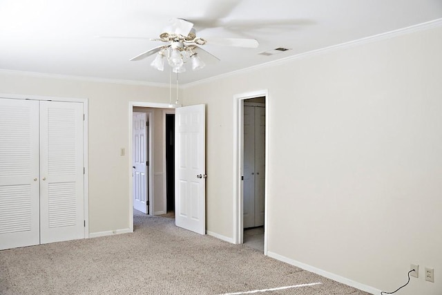 unfurnished bedroom featuring ornamental molding, light colored carpet, a closet, and ceiling fan