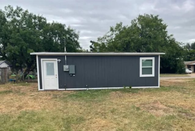 view of outbuilding featuring a lawn