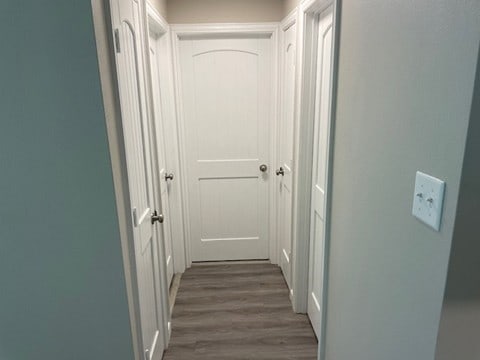 corridor featuring dark wood-type flooring