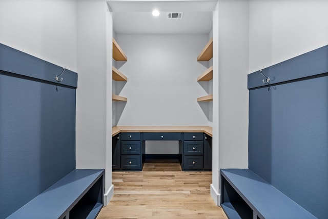 mudroom featuring built in desk, built in features, and light hardwood / wood-style floors