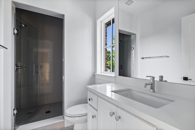 bathroom with walk in shower, vanity, and toilet