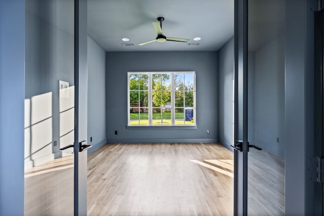 empty room featuring ceiling fan and light wood-type flooring