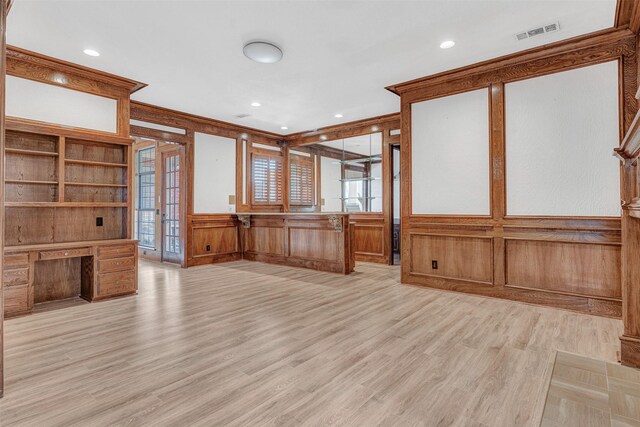 empty room featuring crown molding and light hardwood / wood-style floors