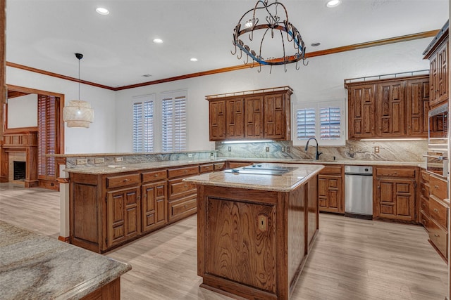 kitchen with decorative backsplash, decorative light fixtures, a kitchen island, and light hardwood / wood-style flooring