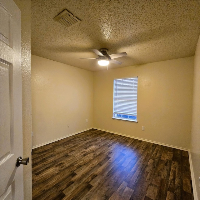 unfurnished room with ceiling fan, dark hardwood / wood-style floors, and a textured ceiling