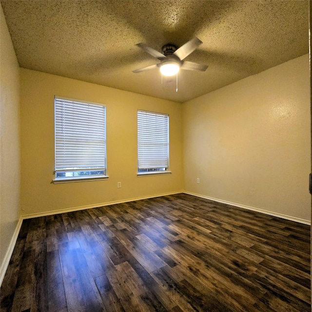 unfurnished room featuring ceiling fan, dark hardwood / wood-style flooring, and a textured ceiling