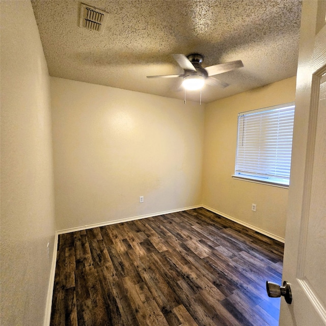 spare room with ceiling fan, dark hardwood / wood-style flooring, and a textured ceiling