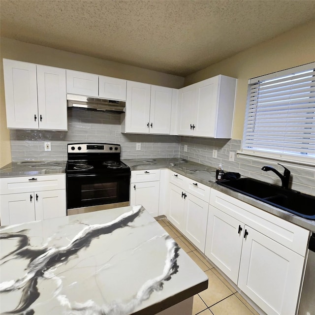 kitchen with white cabinetry, black electric range oven, sink, and light tile patterned floors