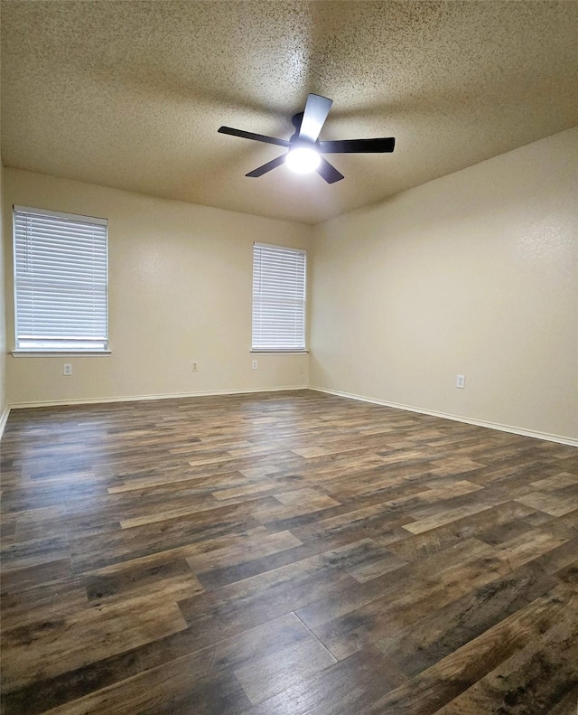 empty room with dark wood-type flooring, ceiling fan, and a textured ceiling