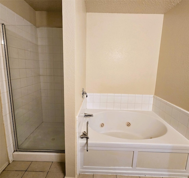 bathroom with tile patterned flooring, independent shower and bath, and a textured ceiling