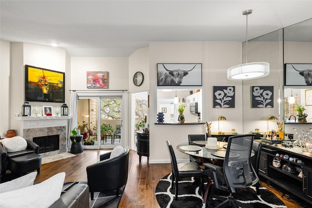 kitchen featuring white appliances, tasteful backsplash, white cabinets, decorative light fixtures, and a sink