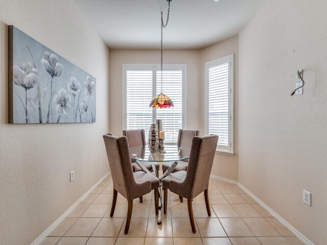 dining space featuring light tile patterned flooring