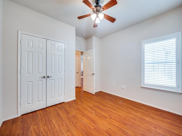 living room with hardwood / wood-style flooring, plenty of natural light, and ceiling fan