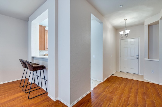 entryway featuring an inviting chandelier and light hardwood / wood-style floors