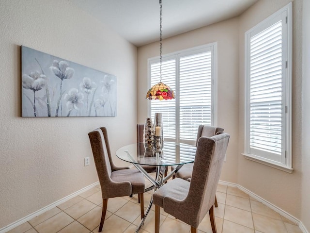 dining space featuring light tile patterned floors