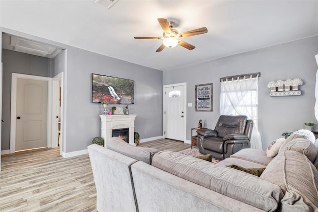 living room featuring light hardwood / wood-style floors and ceiling fan
