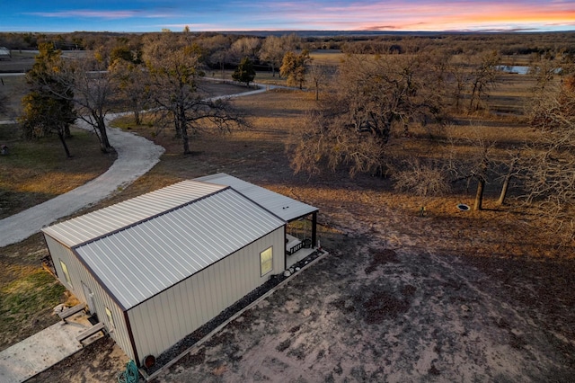 aerial view at dusk featuring a rural view