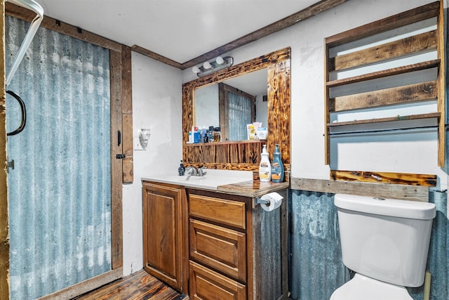 bathroom featuring vanity, hardwood / wood-style floors, and toilet
