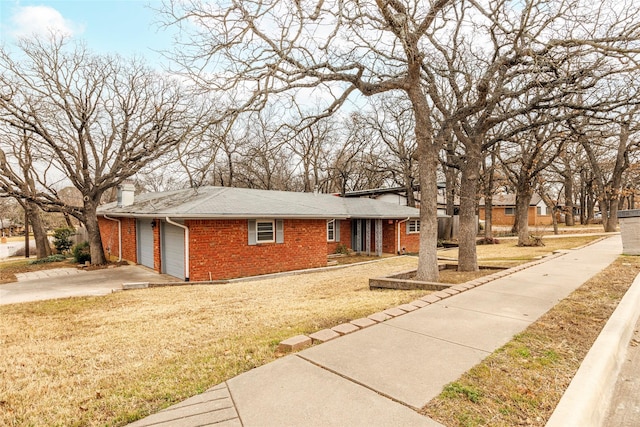 view of front of house with a garage and a front lawn