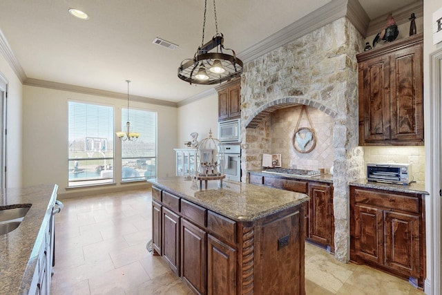 kitchen with white appliances, visible vents, decorative backsplash, and crown molding