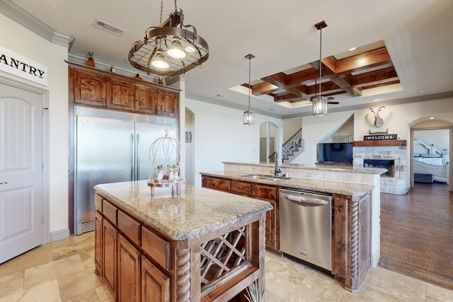 kitchen featuring stainless steel appliances, visible vents, a sink, an island with sink, and coffered ceiling