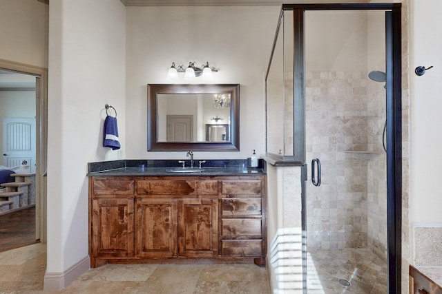 bathroom featuring a stall shower, baseboards, stone finish floor, and vanity