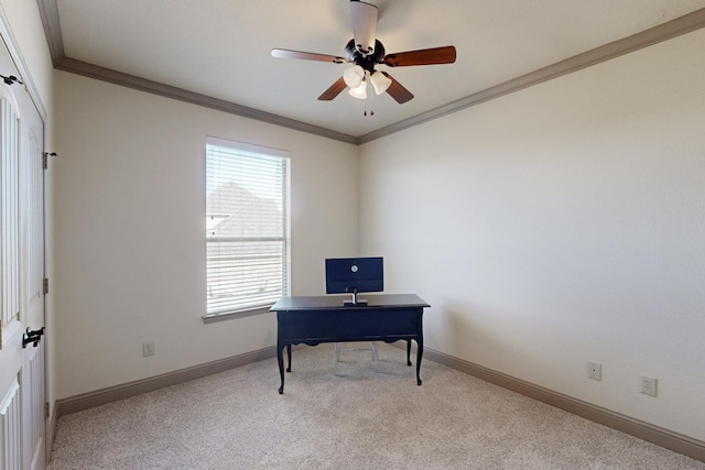 carpeted office space featuring crown molding, baseboards, and ceiling fan