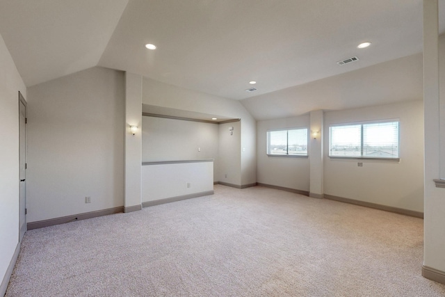 spare room with lofted ceiling, visible vents, baseboards, and recessed lighting