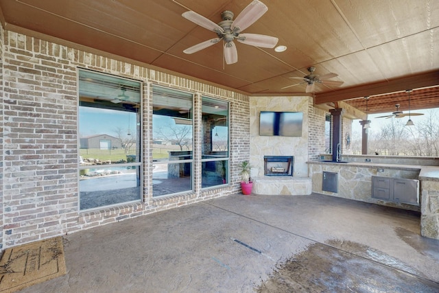 view of patio with ceiling fan and an outdoor kitchen