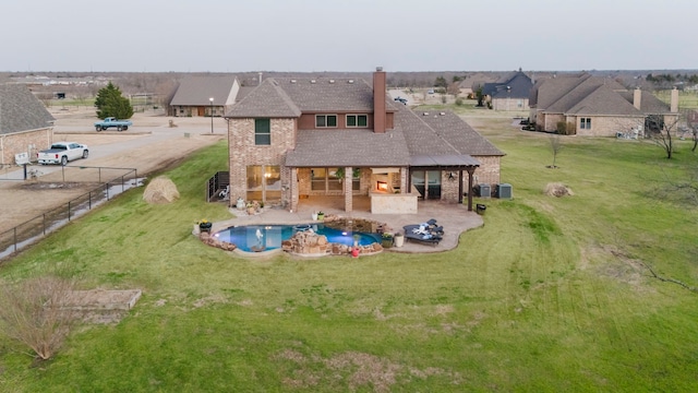 rear view of house with a yard, a patio area, and fence