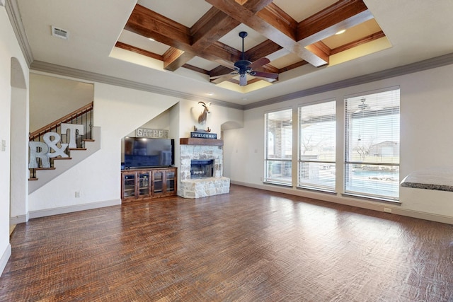 living room featuring ceiling fan, coffered ceiling, a fireplace, baseboards, and crown molding