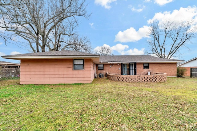 rear view of property with a yard