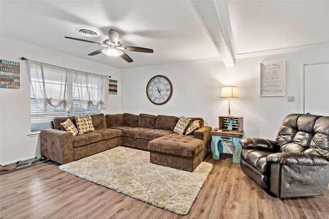 living room featuring beamed ceiling, ceiling fan, crown molding, and light hardwood / wood-style floors