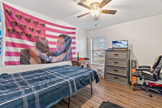 bedroom with ceiling fan and hardwood / wood-style floors