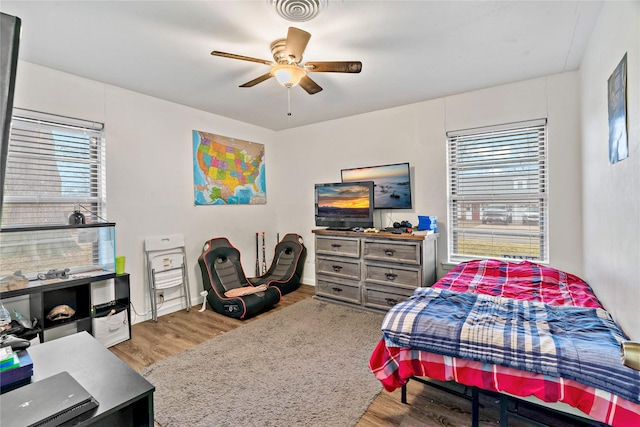 bedroom with hardwood / wood-style flooring and ceiling fan